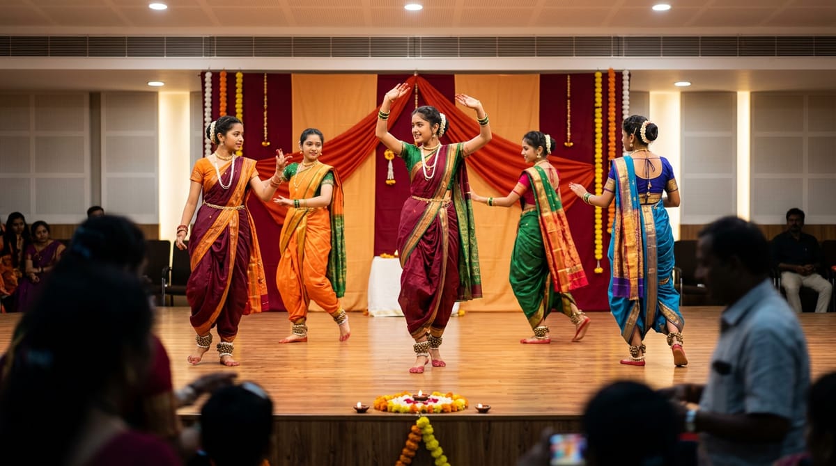Five young women in traditional attire are performing a dance on stage.
